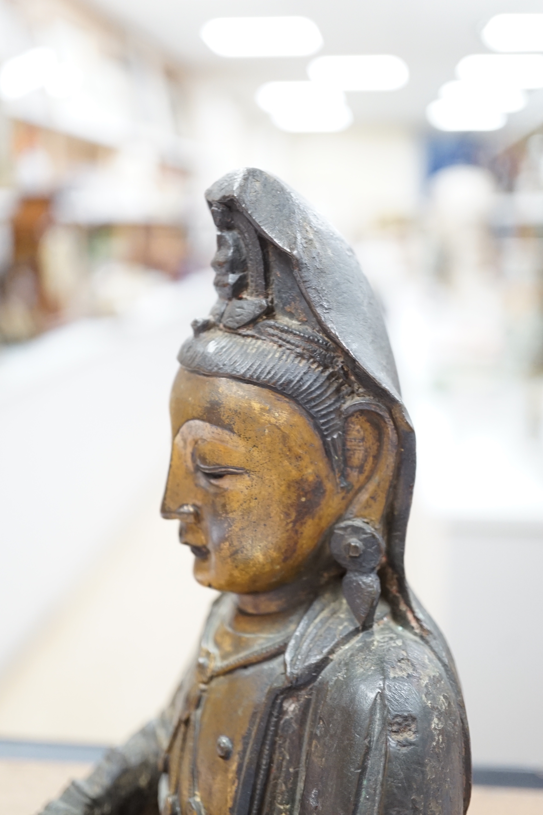 A Chinese Ming gilt bronze figure of Xi Wangmu, Queen Mother of the West, late 16th / early 17th century, Provenance: bought from the 50th Chelsea Antiques Fair, R & D Coombes, 1980, 24cm high